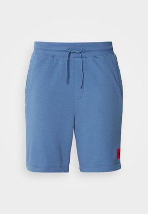 Light blue cotton shorts with an elastic waistband and adjustable drawstring. Features side pockets and a red logo patch on the left leg.