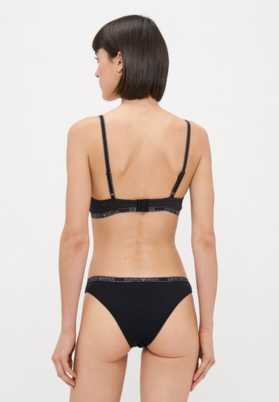 Black lingerie set featuring a bra with adjustable straps and a clasp back, paired with matching low-rise brief. Smooth fabric, subtle branding.