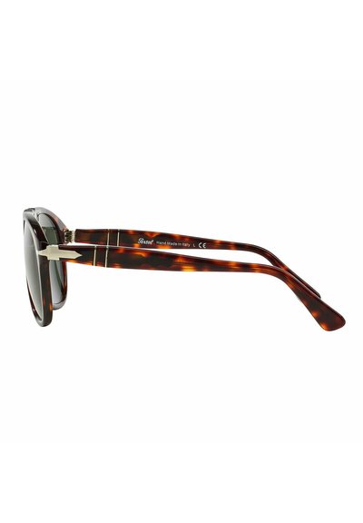 Occhiali da sole tartarugati con un design retrò, caratterizzati da lenti scure e eleganti dettagli in metallo sulle tempie. Fatto a mano in Italia.