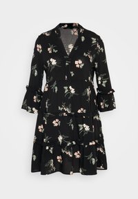 Schwarzes Kleid mit floralen Mustern in Pink und Grün, mit gestuftem Design, Rüschensäumen und V-Ausschnitt. Leichter Stoff.