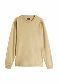 Beżowa bawełniana koszulka z długim rękawem i okrągłym dekoltem. Wyposażona w małe logo "Tommy Jeans" w białym kolorze oraz subtelną teksturę. Standardowy krój.
