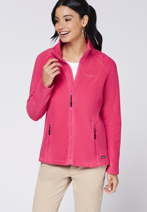 Fleece jacket in bright pink with a high collar, two zippered pockets, and embroidered logo. Soft texture and a fitted design.