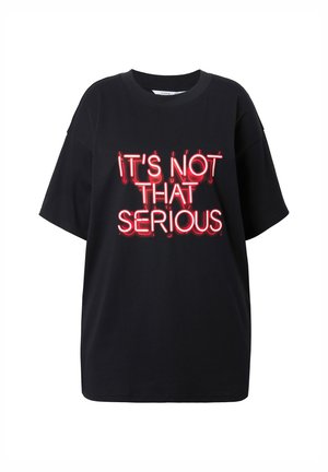 Black oversized t-shirt with short sleeves. Features a neon-style graphic in red that reads, "IT'S NOT THAT SERIOUS." Smooth cotton fabric.