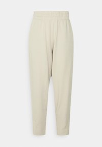Lys beige, bomuldsblanding joggers med elastisk talje, tapered ben og sideslids detaljer. Har broderet logo på hoften.