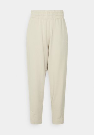 Licht beige, katoenen joggingbroek van een katoenmix met elastische tailleband, taps toelopende benen en zijslits. Voorzien van geborduurd logo op de heup.