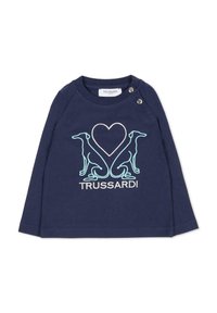 Chemise à manches longues bleu marine avec des manches raglan, ornée de broderies en silhouette de chien blanche et turquoise ainsi qu'un motif de cœur. Détail de fermeture à pression.