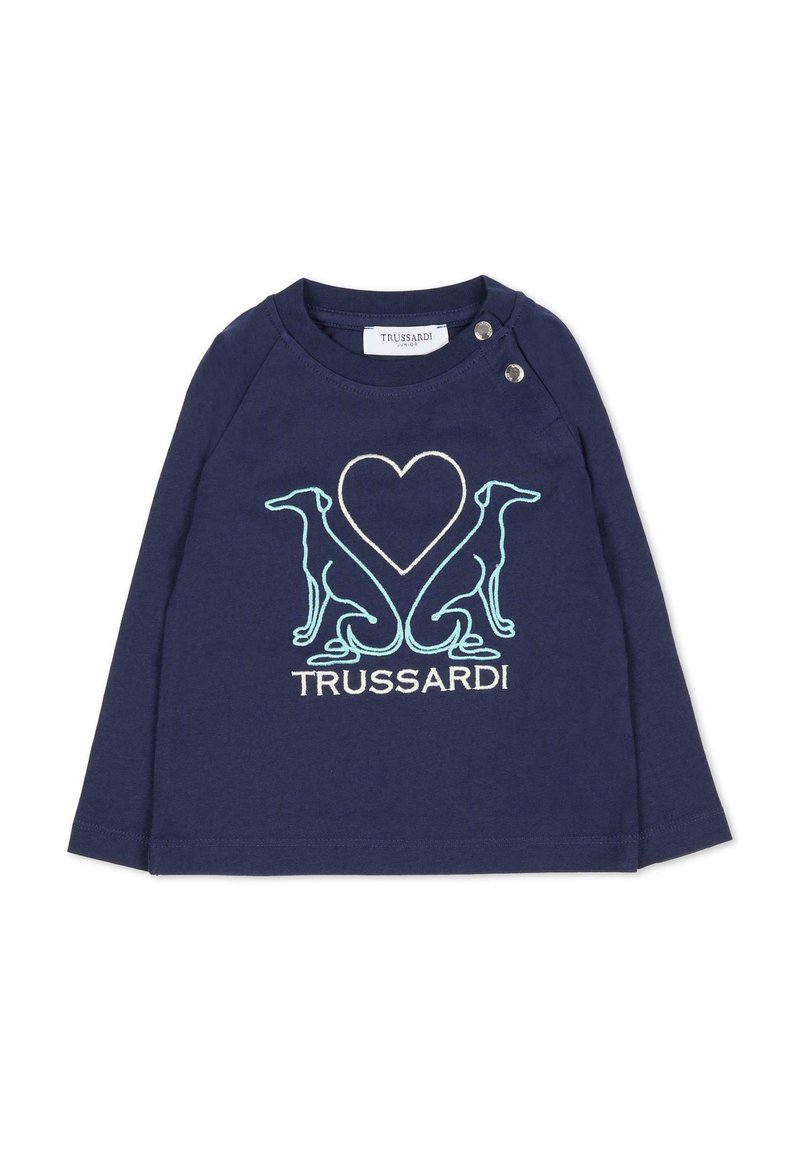 Chemise à manches longues bleu marine avec des manches raglan, ornée de broderies en silhouette de chien blanche et turquoise ainsi qu'un motif de cœur. Détail de fermeture à pression.