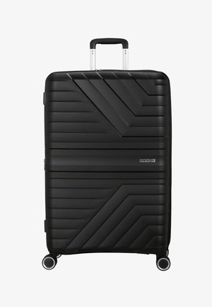Valigia rigida nera con un motivo a linee diagonali, superficie texturizzata, manico argentato e quattro ruote per la mobilità. Design compatto.