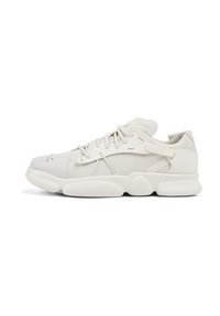 White sneaker features a smooth leather upper, cushioned sole with rounded accents, and lace-up closure with strap detail on the side.