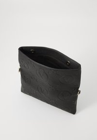 Black leather bag featuring embossed logo patterns, flat rectangular shape, open top with snap closure, and smooth interior lining.