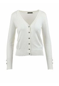 Vit kofta i mjukt tyg med V-ringning, långa ärmar och sex silverknappar framtill. Subtil logotypdetalj vid fållen.