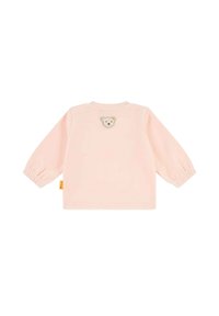 Camisa de manga larga en color rosa claro, hecha de un material suave, que cuenta con mangas elásticas y un pequeño oso bordado con un lazo amarillo en la parte de atrás.