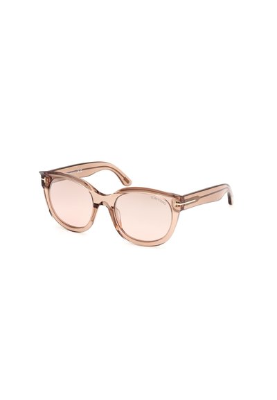 Occhiali da sole Tom Ford con montatura traslucida color pesco, lenti ovali e aste sottili con dettagli dorati. Texture liscia senza motivi.