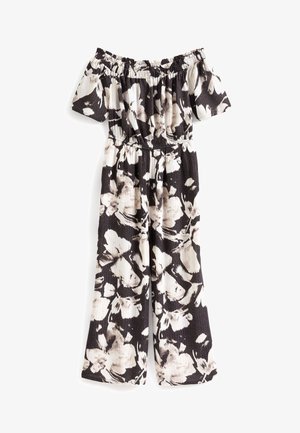 Mono floral con hombros descubiertos en negro y crema, con cintura fruncida, mangas cortas y diseño de pierna ancha con tela texturizada.