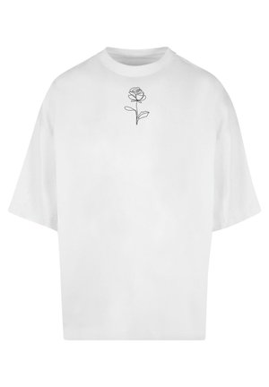 T-shirt blanc surdimensionné en coton, avec un délicat dessin au trait noir d'une rose sur la poitrine. Manches courtes, col rond.