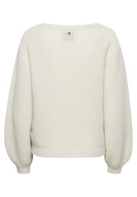 Pull en tricot de couleur crème, à la coupe ample, avec de longues manches bouffantes et un col rond. Il présente un motif texturé et des poignets côtelés.