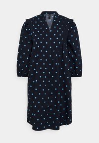 Marinblå klänning med prickar i ljusblått, med V-ringning, trekvartsärmar och volangdetaljer på axlarna.