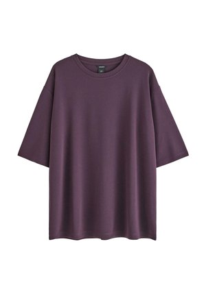 T-shirt viola oversize realizzata in tessuto morbido con colletto rotondo, maniche corte e orlo dritto. Design semplice, senza motivi né dettagli.