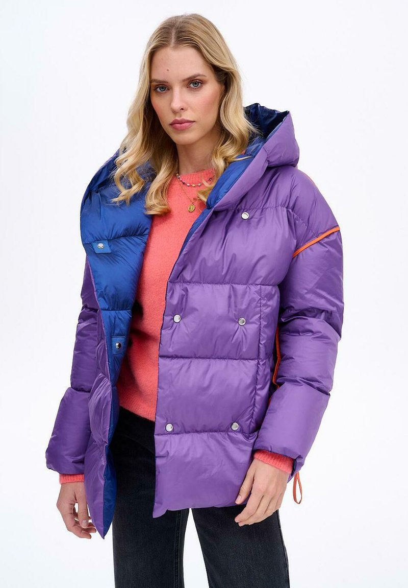 Pufová bunda v purpurovej a modrej farbe s kapucňou, s lesklým povrchom, patentkami a oranžovým akcentom na šve.