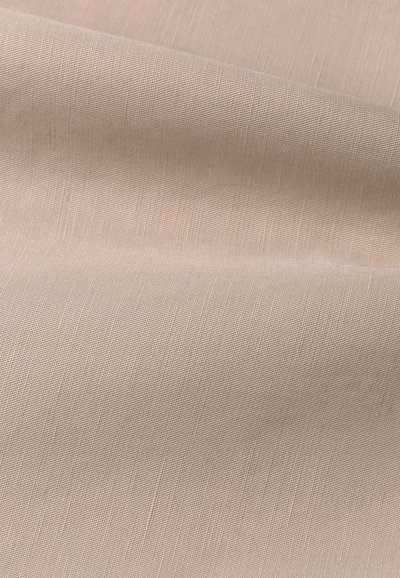 Helles beige, strukturiertes Gewebe mit einem subtilen Webmuster, das sanfte Falten und variierende Lichtreflexionen auf der Oberfläche zeigt.