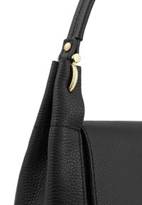 Black textured leather handbag corner with gold metal clasp and a stitched strap against a white background.
