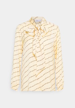 Lichtgele blouse met lange mouwen, voorzien van een diagonale kleine bloemenprint en een grote strik bij de kraag.