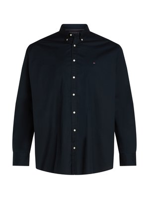 Chemise à manches longues bleu marine avec un col classique, des boutons blancs et un petit logo sur la poitrine gauche. En matériau coton.