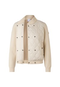 Kremowa kurtka z pikowanym przodem, żebrowanym kołnierzem i mankietami. Wyposażona w czarne guziki napowe oraz miękką, teksturowaną tkaninę.