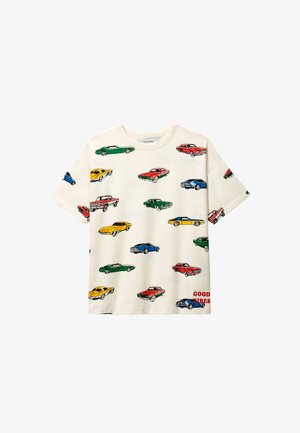 T-shirt en coton crème avec un imprimé répété de voitures colorées en vert, rouge, bleu, jaune et orange. Texte "GOOD VIBES" en rouge.