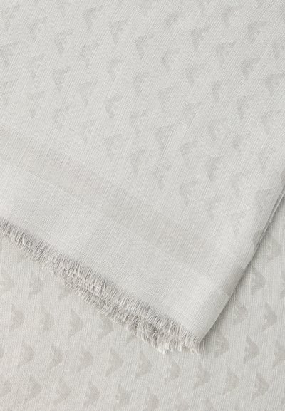 Φωτεινό γκρι υφαντό ύφασμα με διακριτικό επαναλαμβανόμενο σχέδιο και φουντωτή άκρη, διπλωμένο διαγώνια πάνω από ύφασμα με παρόμοιο σχέδιο από κάτω.