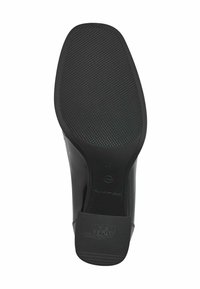 Semelle de chaussure noire avec grip texturé, bout carré, et "Anti-Dérapant" embossé sur le talon pour une résistance au glissement.