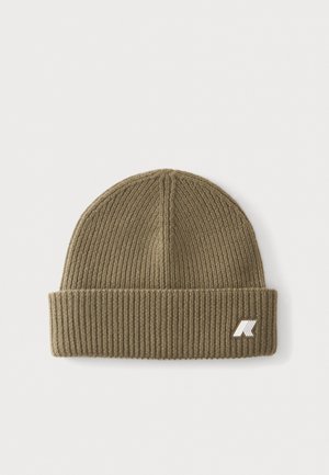 Olive green ribbed knit beanie with a folded cuff and a small white and black logo on the cuff's lower right side.