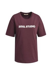 Burgundy cotton t-shirt with short sleeves, round neck, and bold white text reading "SOUL STUDIO" across the chest. Smooth texture.