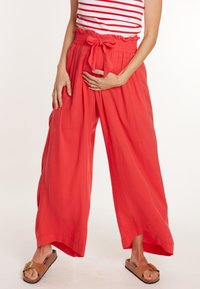 Rode wijde broek met een gerimpelde tailleband en een strikdetail. Gemaakt van een lichte stof, met een losse pasvorm en zijzakken.