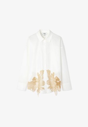 Witte lange mouwen blouse met een knoopsluiting aan de voorkant, met ingewikkelde gouden bloemenborduursels aan de zoom. Gemaakt van een lichtgewicht stof.