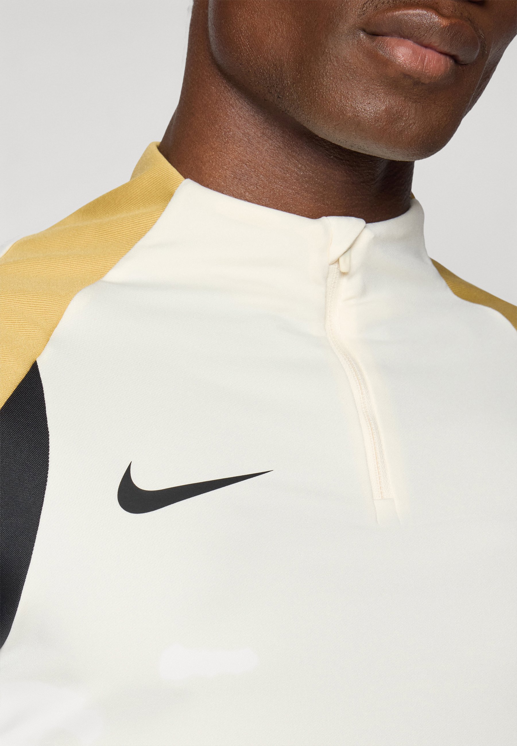 white and gold nike top