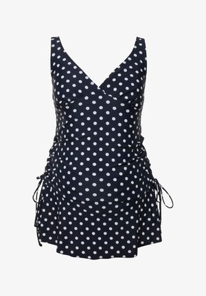 Marineblå bikini med polkaprikker, justerbare sidebindinger, rynket liv og en udskudt nederdel. Stoffet har en glat, blank overflade.