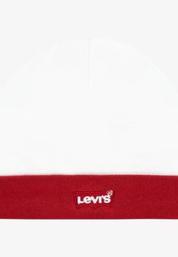 Bomullsmössa med vit topp och röd ribbad mudd. Har en liten, broderad Levi's-logga i vitt på mudden.