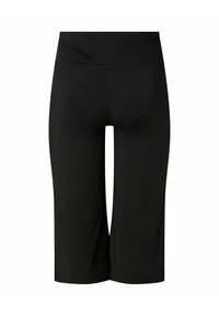 Leggings capri noirs taille haute en tissu extensible, vus de dos avec une finition lisse et une large ceinture.