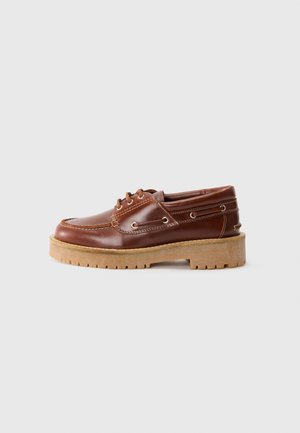 Brown leather shoes with a rounded toe, lace-up front, and rubber sole. Features metal accents and contrasting stitching.