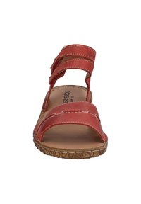 Red leather sandal with two horizontal straps and an open toe design. Features stitched accents and a textured natural look outsole.