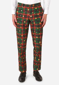 Grüne, rote und schwarze karierte Hosen mit goldenen Sternmustern. Das Material wirkt leicht und glatt. Sie haben einen Frontknopf und einen Reißverschluss.