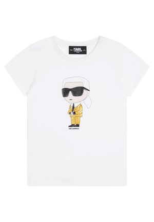 Valkoinen lyhythihainen lasten t-paita, jossa sarjakuvahahmo aurinkolaseissa ja keltakuvioinen puku, alla teksti "KARL LAGERFELD".