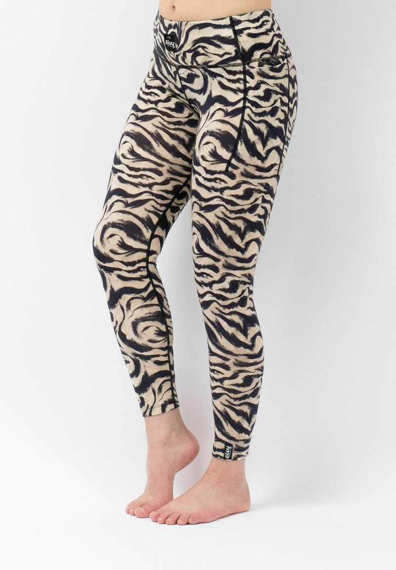 Strakke leggings in een beige en zwarte tijgerprint, met een fitted tailleband en een enkellabel voor branding.