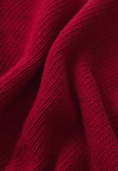Red knit fabric featuring a soft texture with visible ribbing. The material appears warm and lightweight, suitable for clothing items.