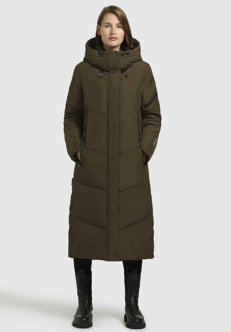 Dlouhá, olivově zelená péřová bunda s vysokým límcem, zipovými kapsami a kovovými druky na straně. Má prošívaný design a kapuci.