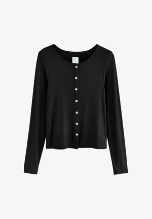 Črn dolgi kardigan s dolgimi rokavi iz rebrastega materiala. Ima okrogel izrez in vrsto belih gumbov spredaj.