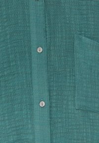 Teal linen button-up shirt with a textured finish, featuring small, round buttons and a pocket on the left side.