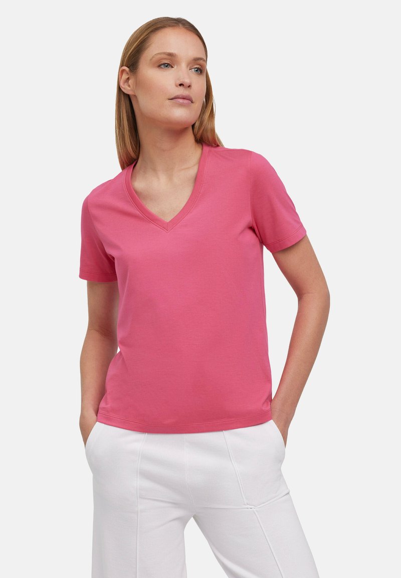 Roze v-hals t-shirt van zacht stof, met korte mouwen en een ontspannen pasvorm. Gekenmerkt door een casual stijl, gecombineerd met witte broeken.