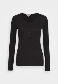 Svart långärmad topp i ribbat material med rund halsringning och en rad med sex knappar fram. Slät yta, inga mönster.